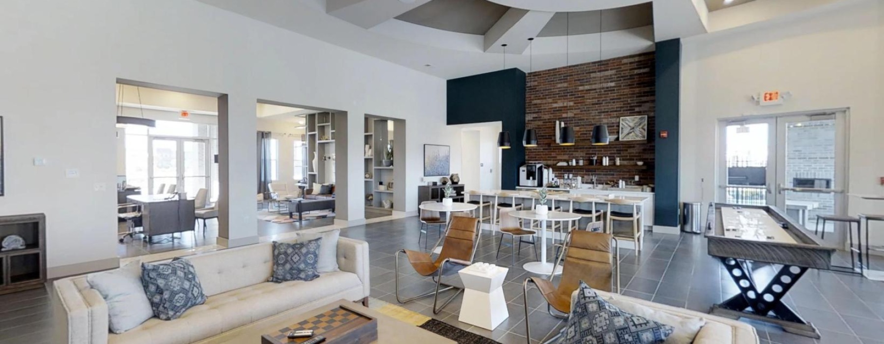 a clubroom with couches, tables and chairs