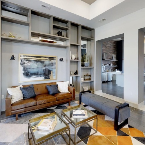 a clubroom with a couch, tables and chairs