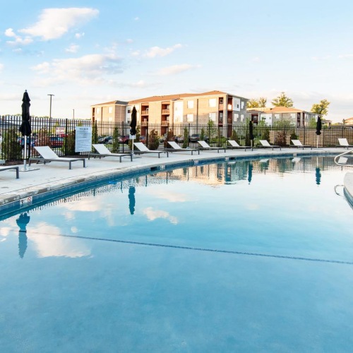 a swimming pool with lounge chairs