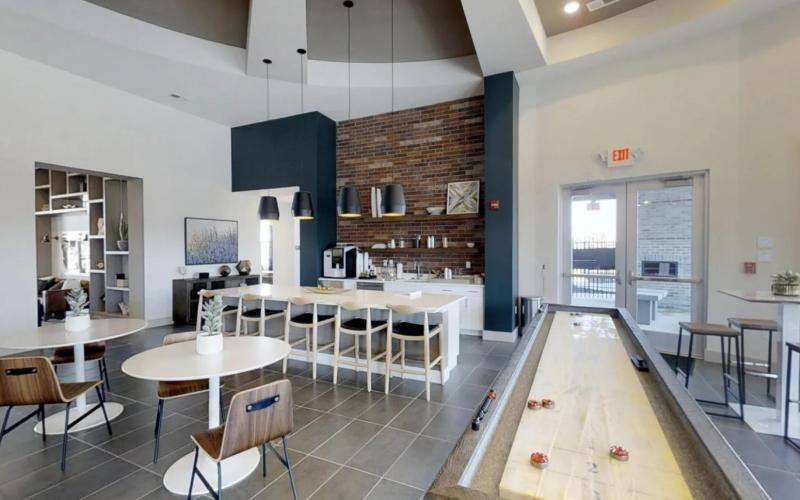 a clubroom with tables and chairs